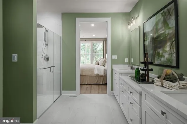 a en suite bathroom with a double vanity sink and a mirror