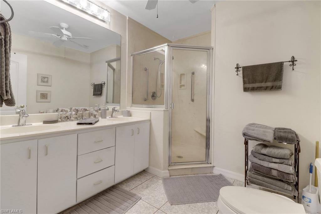 562 Goldcoast Court Marco Island, FL 34145 - Photo 12 of 28 a bathroom with a toilet a sink and mirror