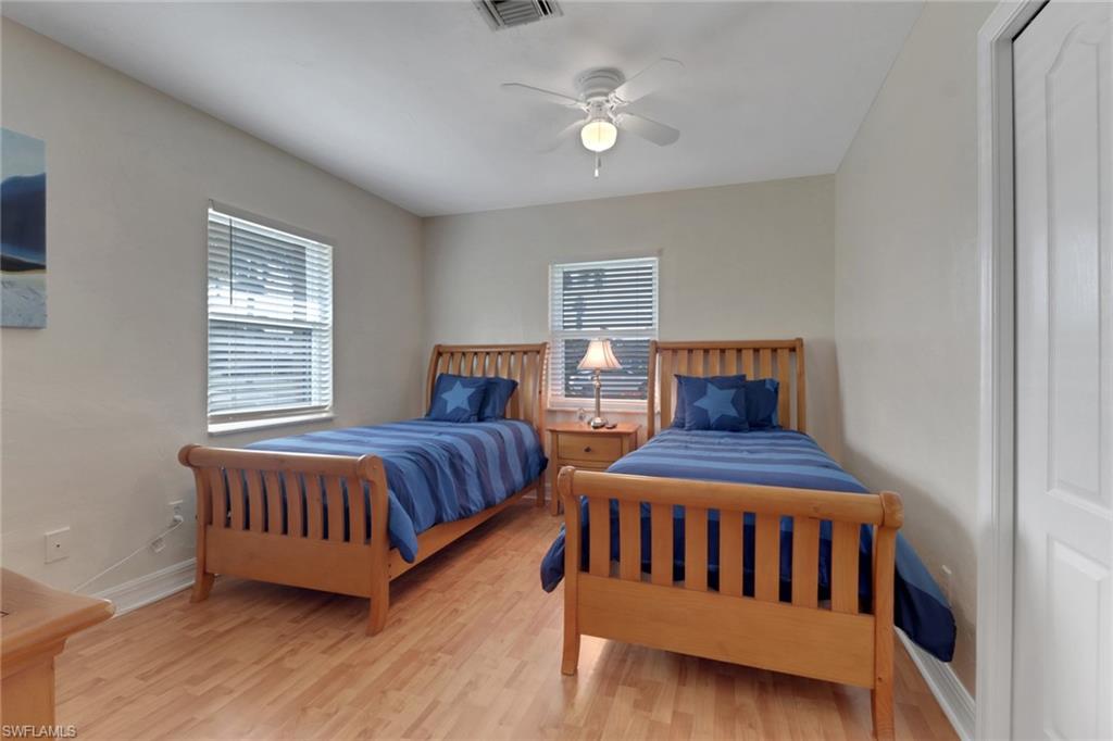 562 Goldcoast Court Marco Island, FL 34145 - Photo 14 of 28 a bedroom with furniture and a window