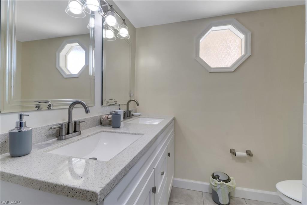 562 Goldcoast Court Marco Island, FL 34145 - Photo 16 of 28 a bathroom with a sink and a mirror