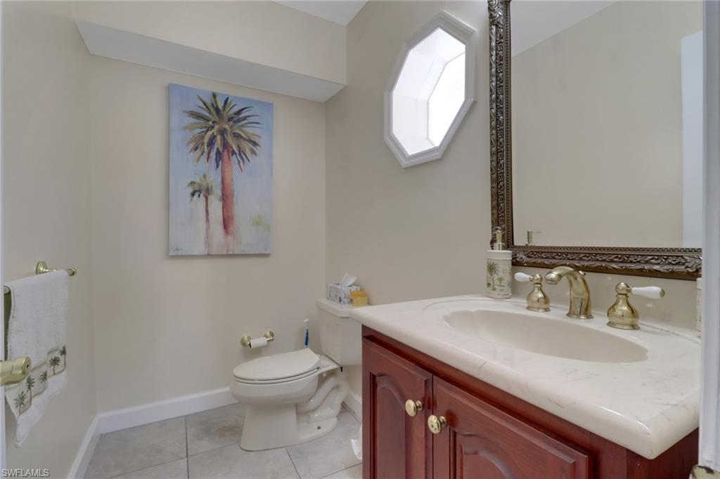 562 Goldcoast Court Marco Island, FL 34145 - Photo 17 of 28 a bathroom with a toilet a sink and mirror