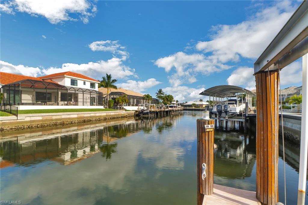 562 Goldcoast Court Marco Island, FL 34145 - Photo 24 of 28 a view of a lake with a house