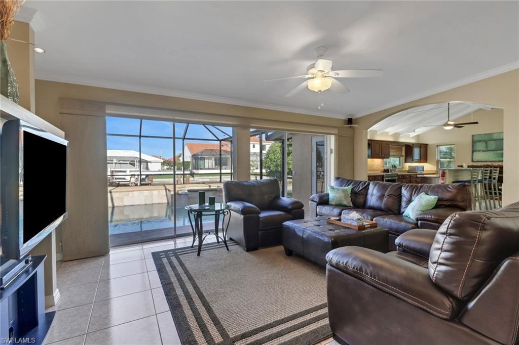 562 Goldcoast Court Marco Island, FL 34145 - Photo 5 of 28 a living room with furniture a large window and a flat screen tv
