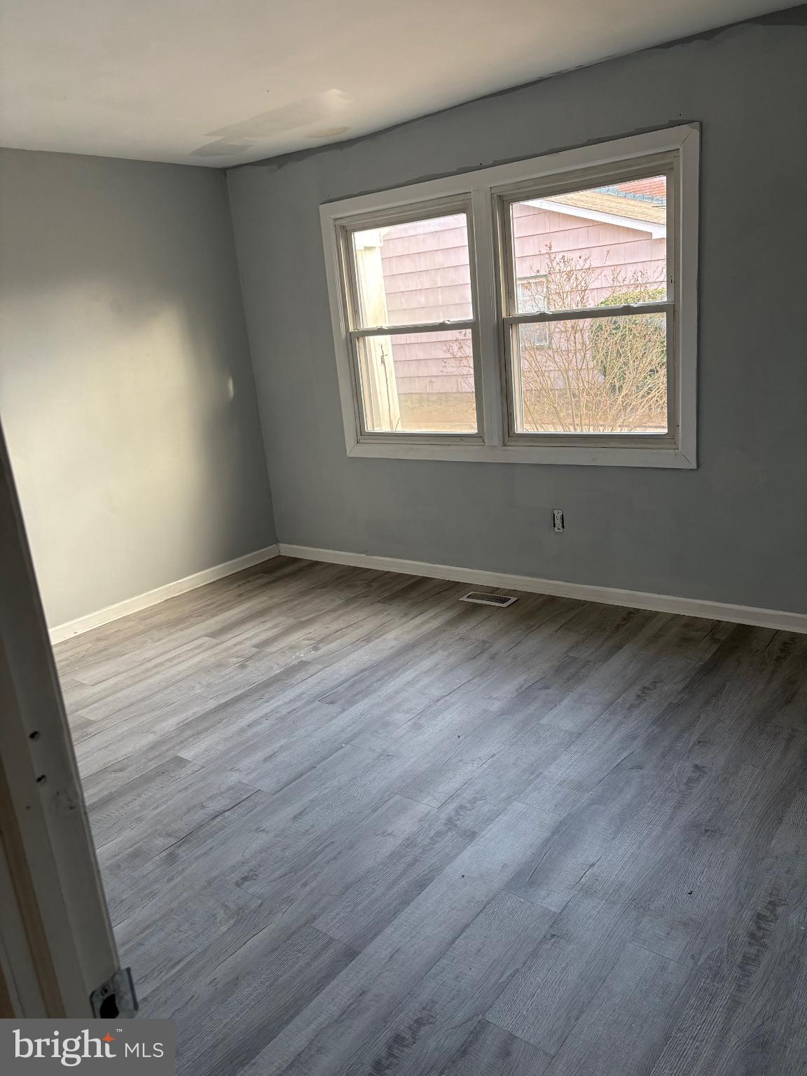 11 Ridgewood Place Willingboro, NJ 08046 - Photo 13 of 14 a view of an empty room with wooden floor and a window