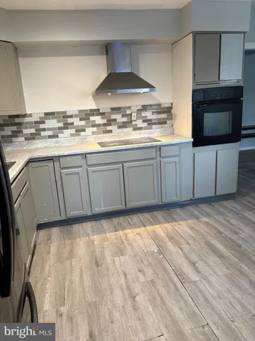 a kitchen with kitchen island granite countertop a stove and a sink