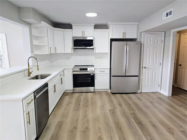 a kitchen with a sink stove and microwave