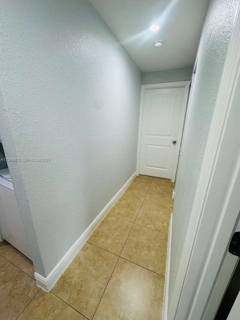 8270 Southwest 149th Court, Unit 10209 Miami, FL 33193 - Photo 17 of 32 an empty room with a bench