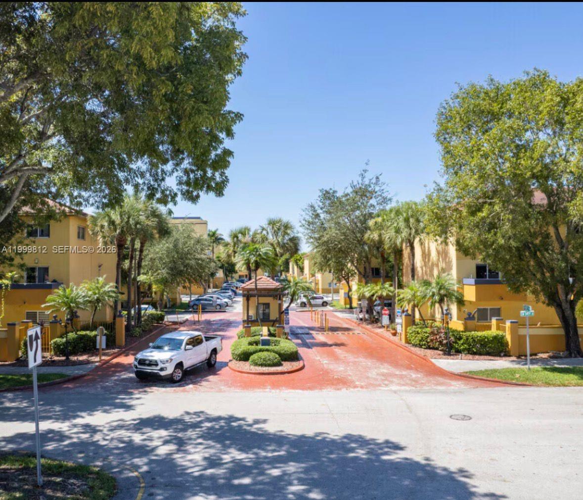 8270 Southwest 149th Court, Unit 10209 Miami, FL 33193 - Photo 2 of 32 a view of a street with houses