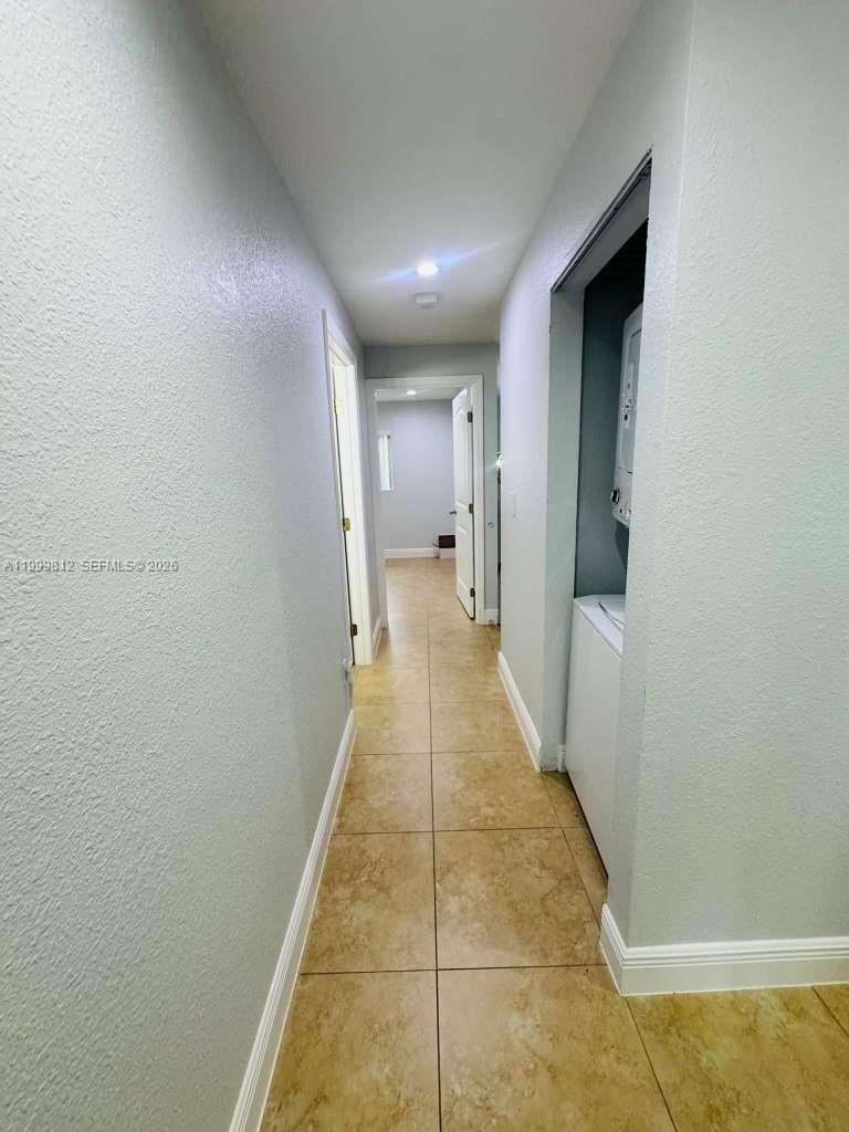 8270 Southwest 149th Court, Unit 10209 Miami, FL 33193 - Photo 24 of 32 a view of a hallway with a white walls