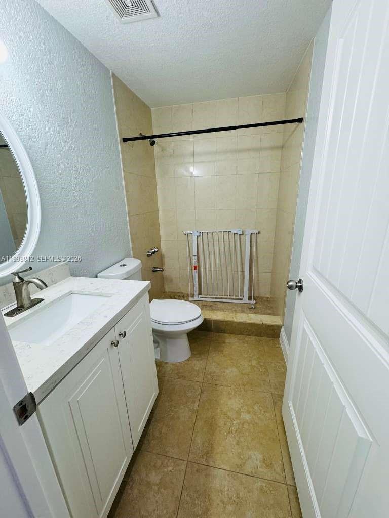 8270 Southwest 149th Court, Unit 10209 Miami, FL 33193 - Photo 27 of 32 a bathroom with a sink toilet and shower