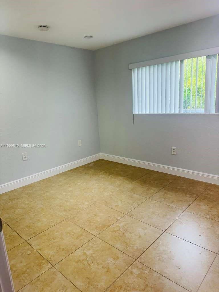 8270 Southwest 149th Court, Unit 10209 Miami, FL 33193 - Photo 28 of 32 an empty room with a window