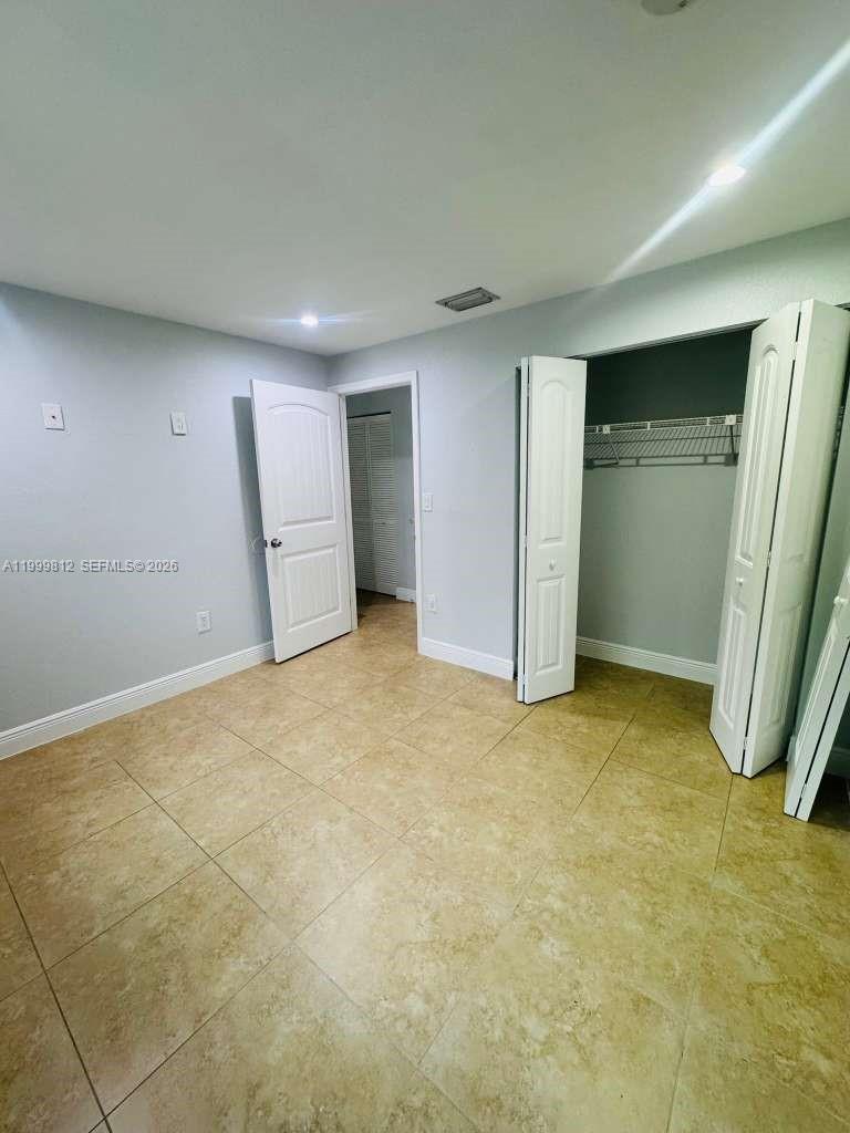 8270 Southwest 149th Court, Unit 10209 Miami, FL 33193 - Photo 29 of 32 an empty room with a fireplace