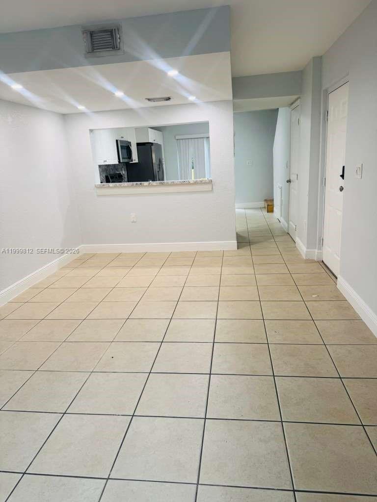 8270 Southwest 149th Court, Unit 10209 Miami, FL 33193 - Photo 8 of 32 a view of an empty room and window