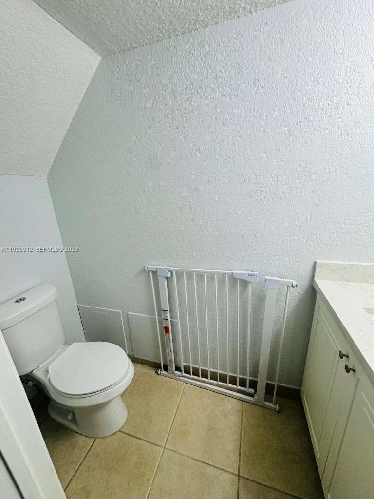 8270 Southwest 149th Court, Unit 10209 Miami, FL 33193 - Photo 9 of 32 a bathroom with a toilet and a shower
