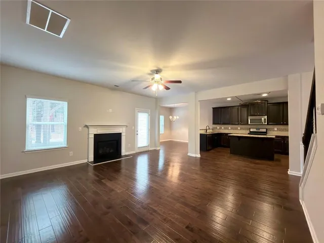 a view of a kitchen with a sink and a large window
