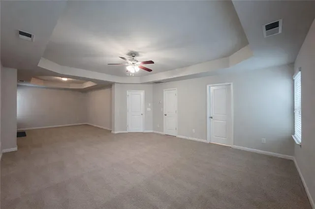 an empty room with fireplace and windows
