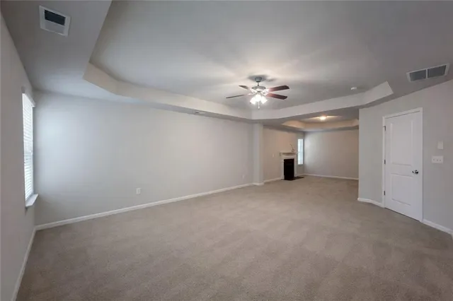 a view of empty room with a fireplace