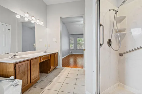 a bathroom with a sink vanity and mirror