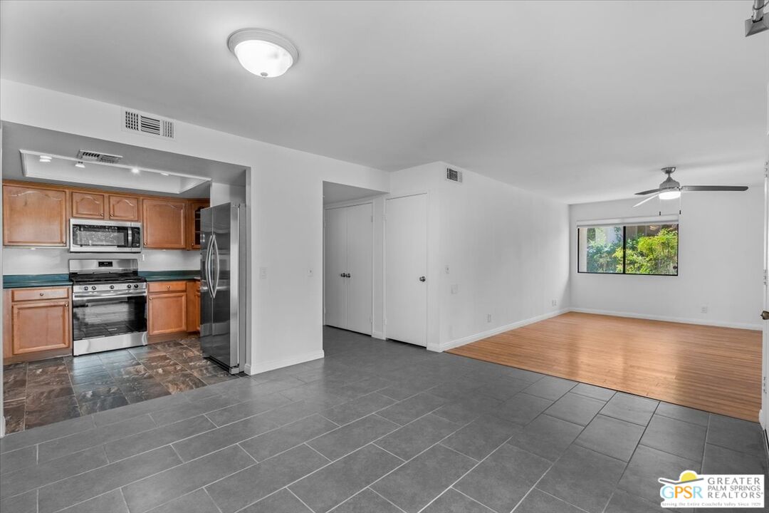 200 East Racquet Club Road, Unit 45 Palm Springs, CA 92262 - Photo 1 of 36 an empty room with kitchen view and a window
