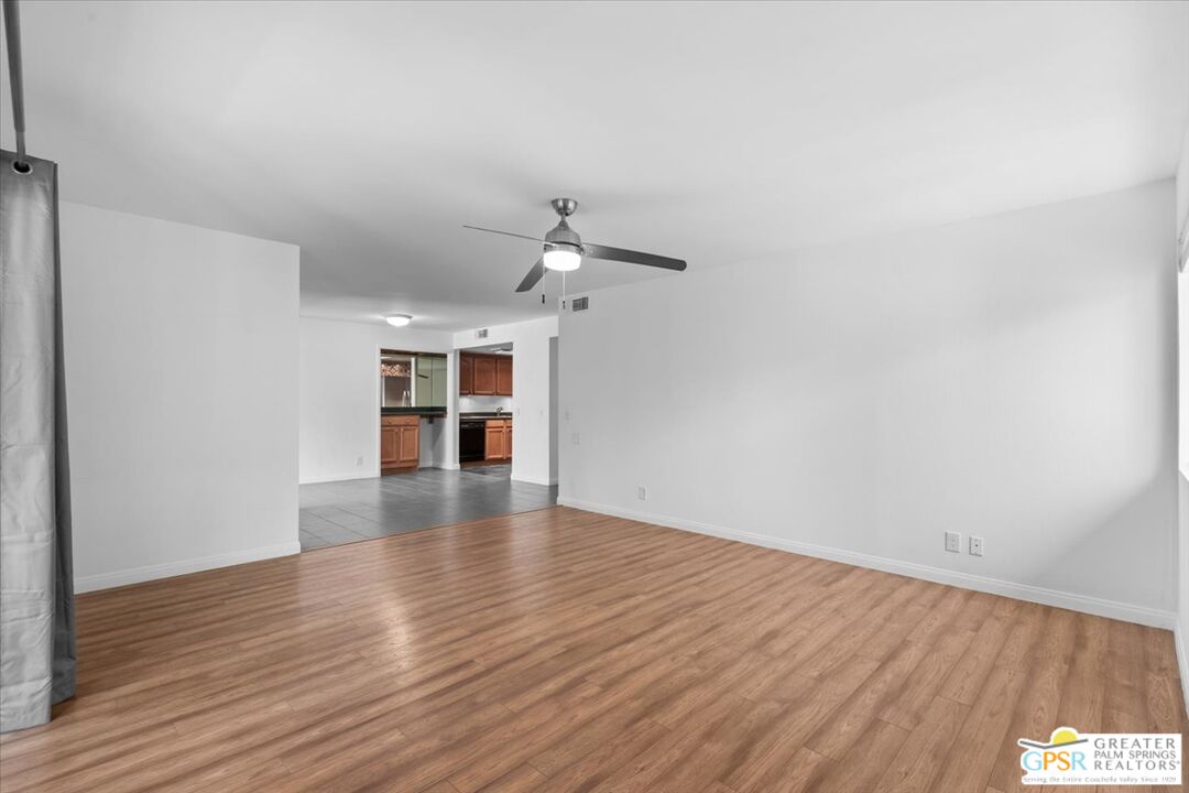 200 East Racquet Club Road, Unit 45 Palm Springs, CA 92262 - Photo 13 of 36 wooden floor in an empty room with a window