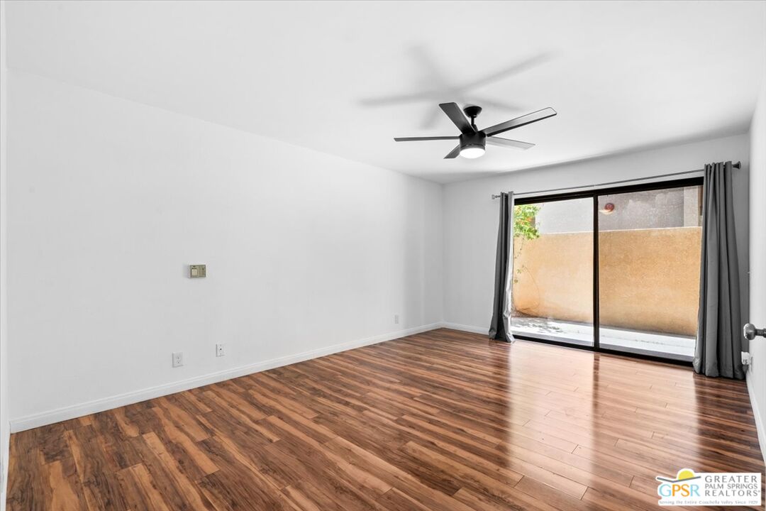 200 East Racquet Club Road, Unit 45 Palm Springs, CA 92262 - Photo 17 of 36 a view of a livingroom with a ceiling fan and a large window
