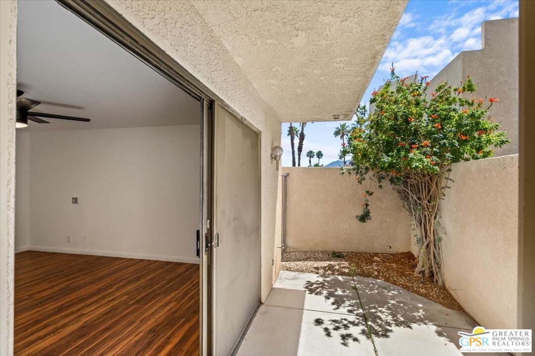 200 East Racquet Club Road, Unit 45 Palm Springs, CA 92262 - Photo 18 of 36 a view of a room with wooden floor and a potted plant