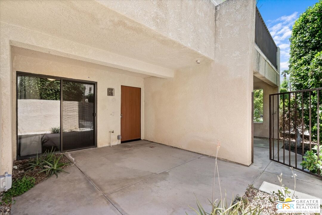200 East Racquet Club Road, Unit 45 Palm Springs, CA 92262 - Photo 2 of 36 a view of a patio with table and chairs and potted plants