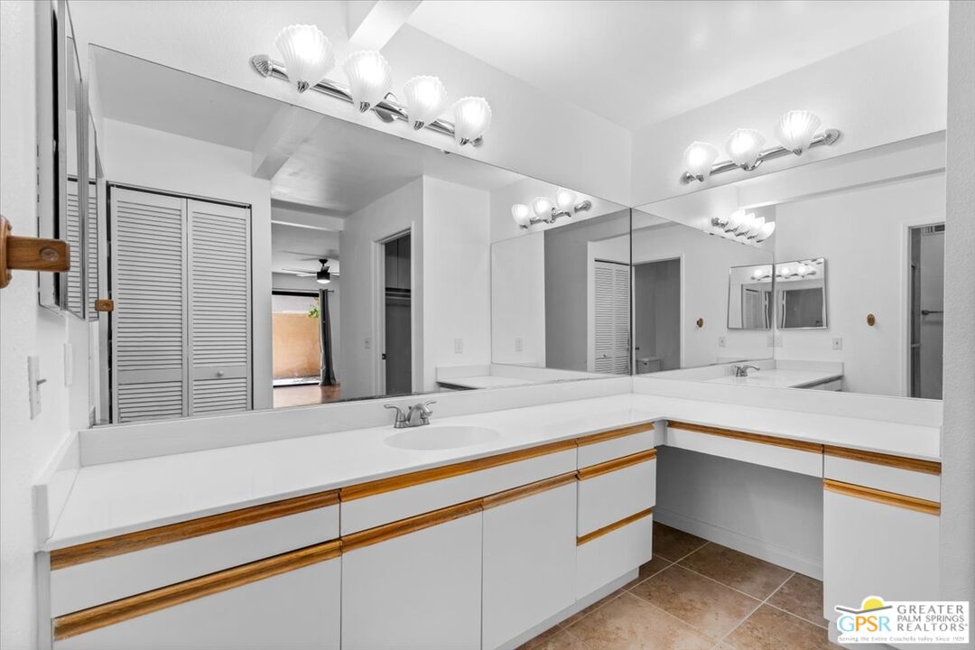 200 East Racquet Club Road, Unit 45 Palm Springs, CA 92262 - Photo 21 of 36 a bathroom with a sink double vanity and a large mirror