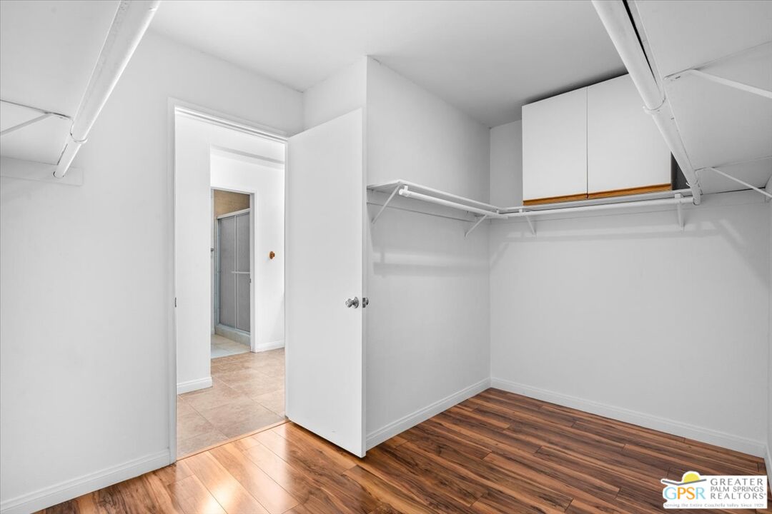 200 East Racquet Club Road, Unit 45 Palm Springs, CA 92262 - Photo 23 of 36 a view of an empty room with wooden floor