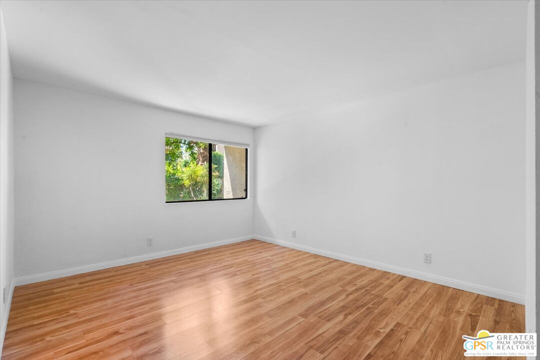 200 East Racquet Club Road, Unit 45 Palm Springs, CA 92262 - Photo 24 of 36 wooden floor in an empty room with a window