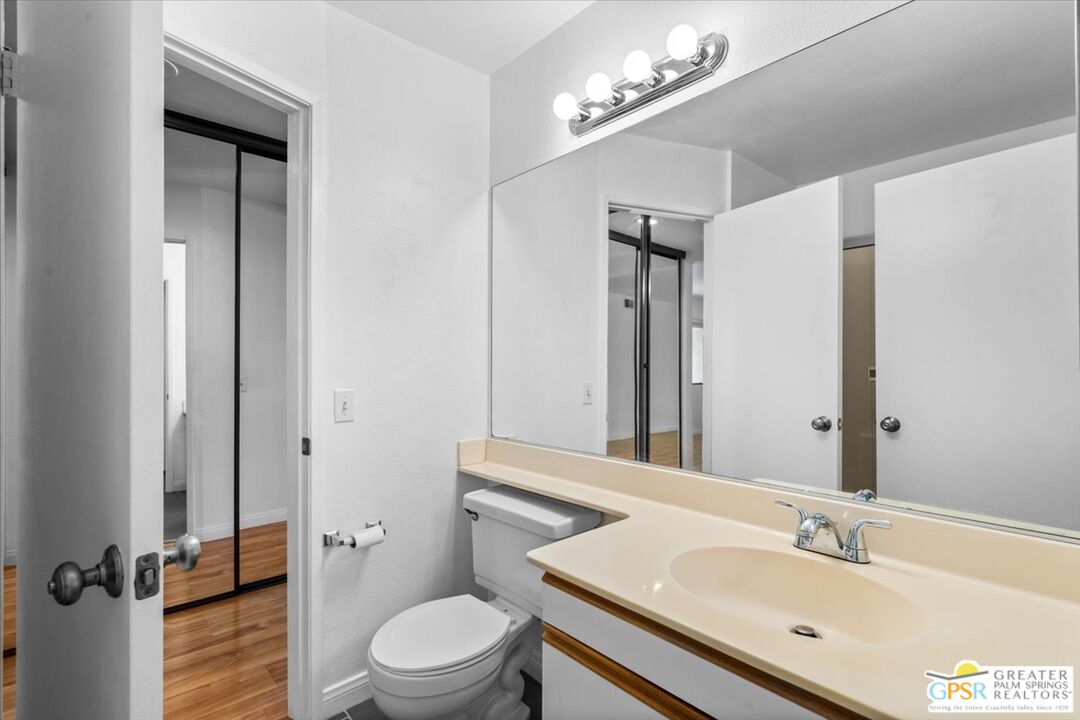 200 East Racquet Club Road, Unit 45 Palm Springs, CA 92262 - Photo 26 of 36 a bathroom with a sink a toilet a mirror and shower