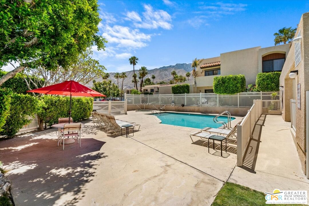 200 East Racquet Club Road, Unit 45 Palm Springs, CA 92262 - Photo 32 of 36 a chair and tables in the patio of a house