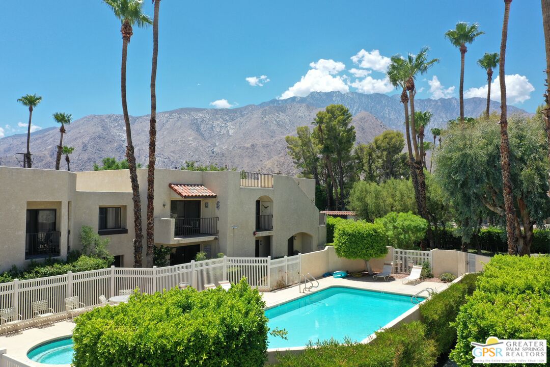 200 East Racquet Club Road, Unit 45 Palm Springs, CA 92262 - Photo 4 of 36 a view of a house with a yard and potted plants