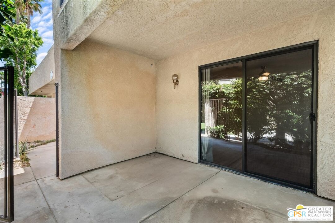 200 East Racquet Club Road, Unit 45 Palm Springs, CA 92262 - Photo 10 of 36 a view of empty room with floor to ceiling window and tree