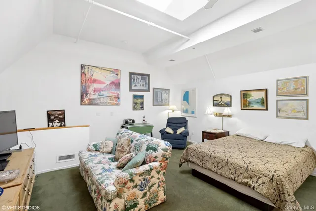 a bedroom with bed couch and window