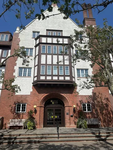 a view of a garden with a building in the background