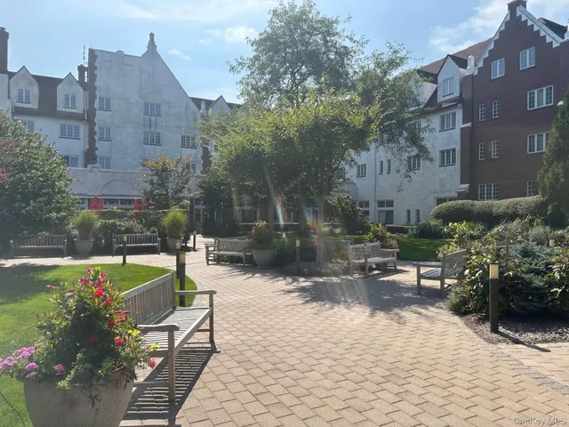 a view of a swimming pool with a yard and sitting area