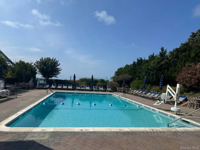 a view of a tennis ground with a big yard
