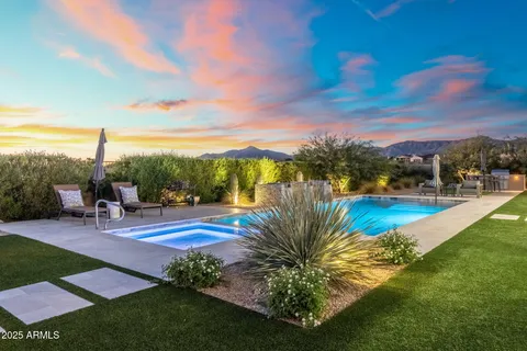 a view of a swimming pool with outdoor seating