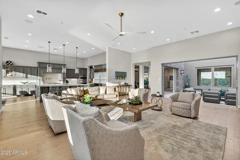a dining room with furniture a chandelier and wooden floor