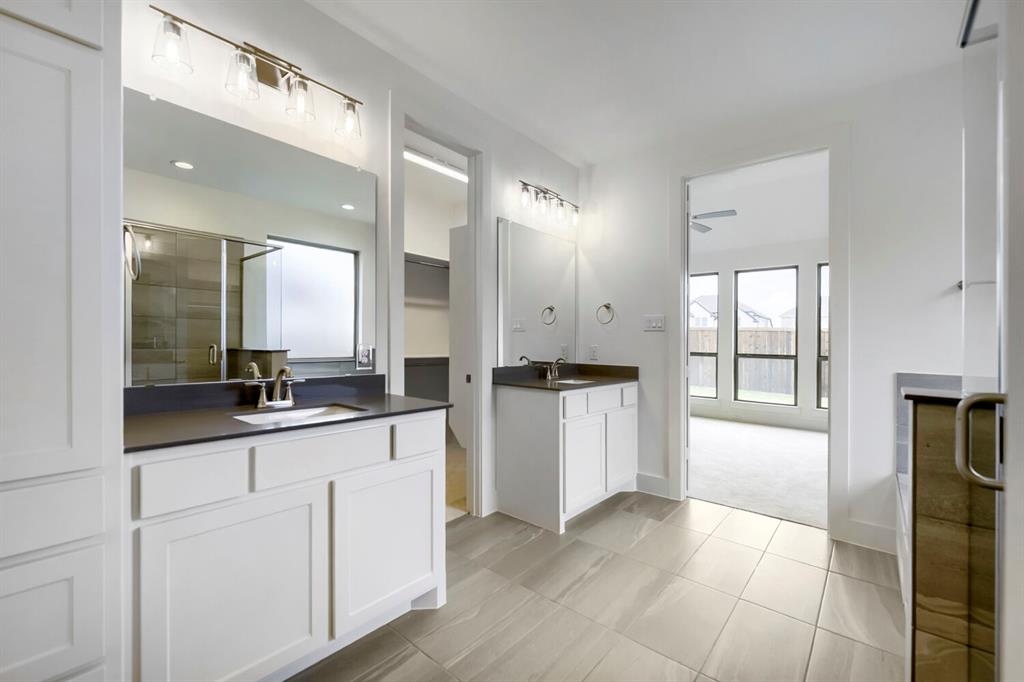 11548 Wulstone Road Haslet, TX 76052 - Photo 15 of 26 Bathroom featuring light-toned tile flooring, dual vanities with dark countertops, and white cabinetry