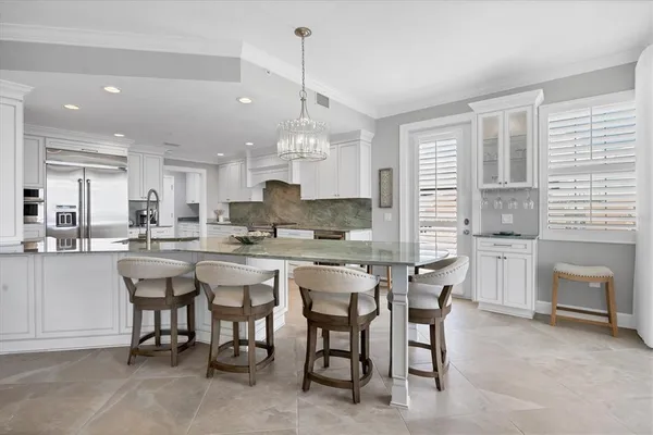 a large kitchen with a table and chairs