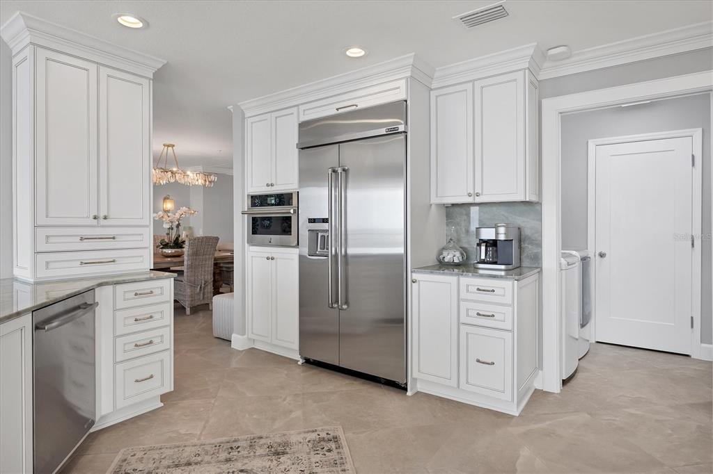 13213 Gasparilla Road, Unit B601 Placida, FL 33946 - Photo 13 of 36 a kitchen with white cabinets and stainless steel appliances