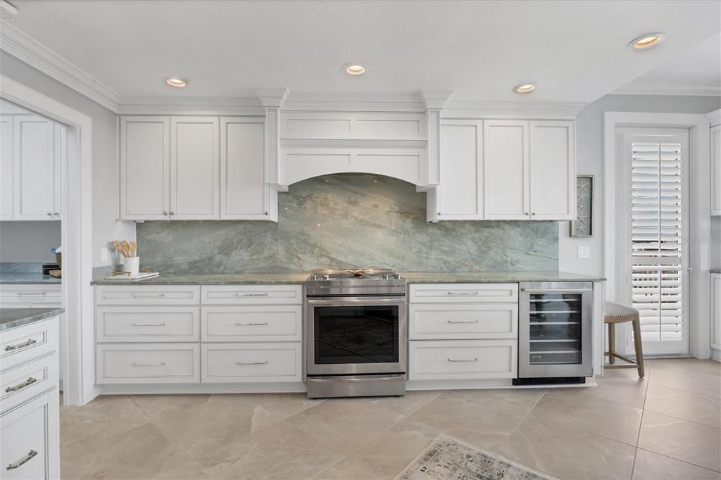 13213 Gasparilla Road, Unit B601 Placida, FL 33946 - Photo 14 of 36 a kitchen with granite countertop white cabinets and stainless steel appliances