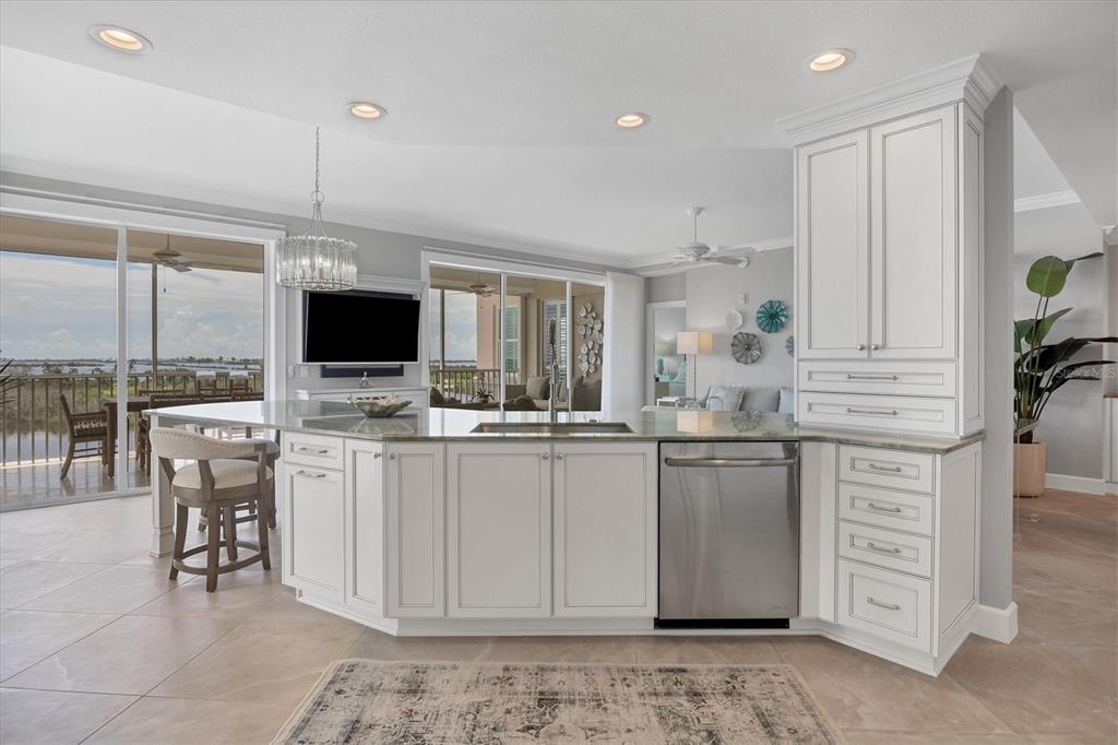 13213 Gasparilla Road, Unit B601 Placida, FL 33946 - Photo 15 of 36 a kitchen with stainless steel appliances kitchen island granite countertop a stove a sink and a microwave