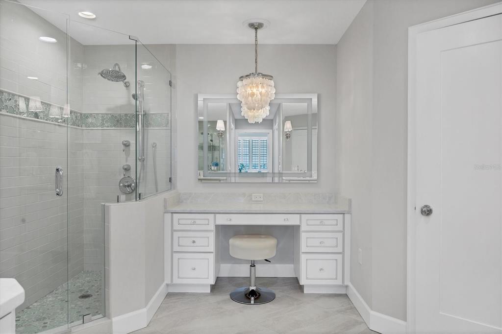 13213 Gasparilla Road, Unit B601 Placida, FL 33946 - Photo 18 of 36 a spacious bathroom with a toilet a sink and a mirror