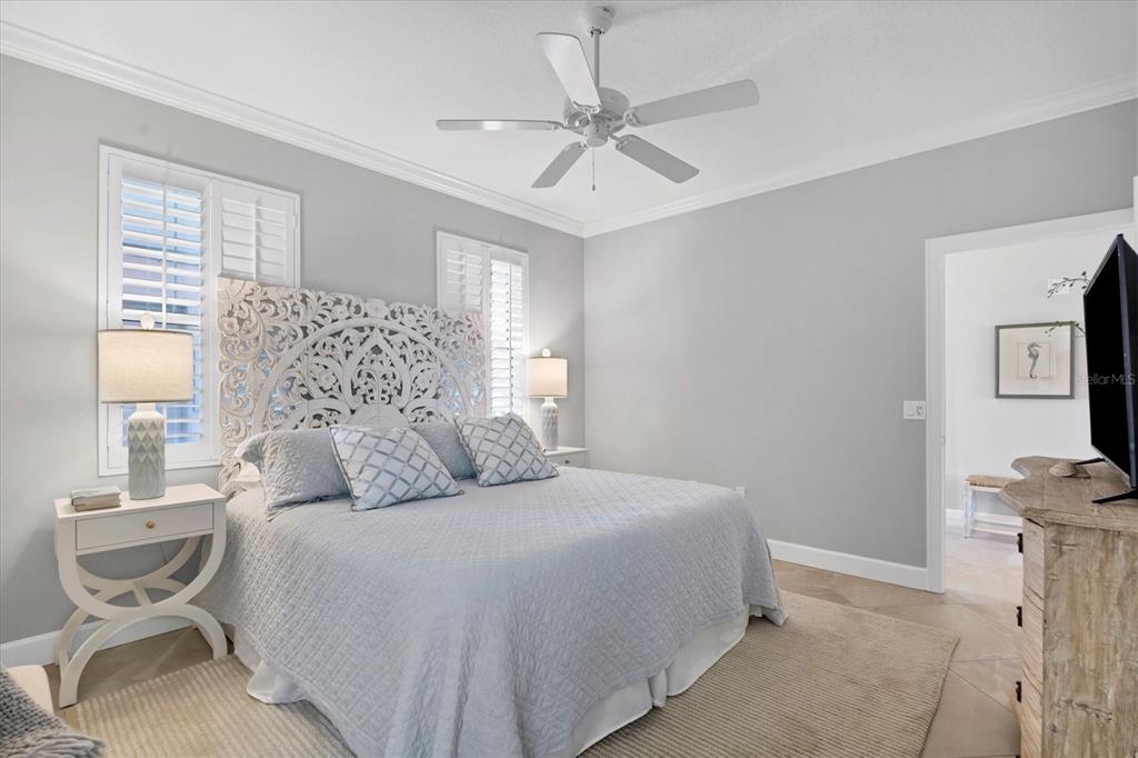 13213 Gasparilla Road, Unit B601 Placida, FL 33946 - Photo 21 of 36 a bedroom with a bed and a chandelier