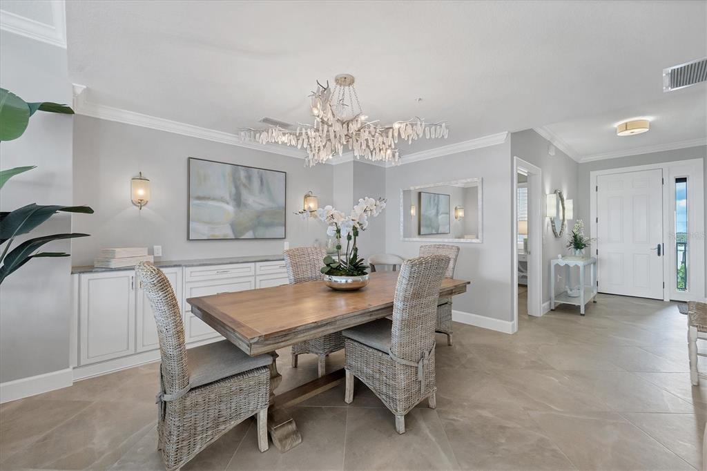 13213 Gasparilla Road, Unit B601 Placida, FL 33946 - Photo 10 of 36 a view of a dining room with furniture and chandelier