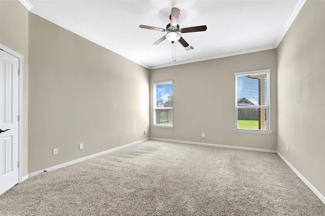 a view of room with window and ceiling fan