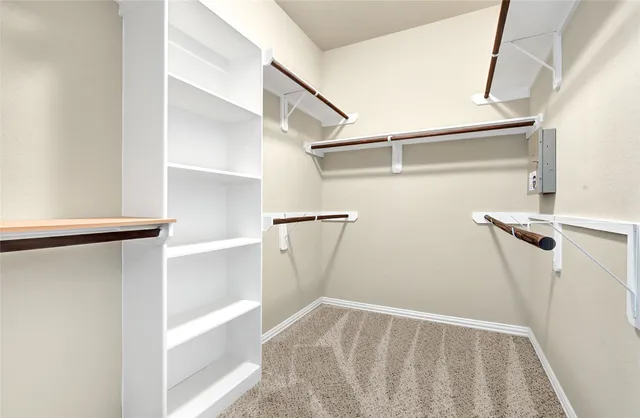 a view of walk in closet with empty racks